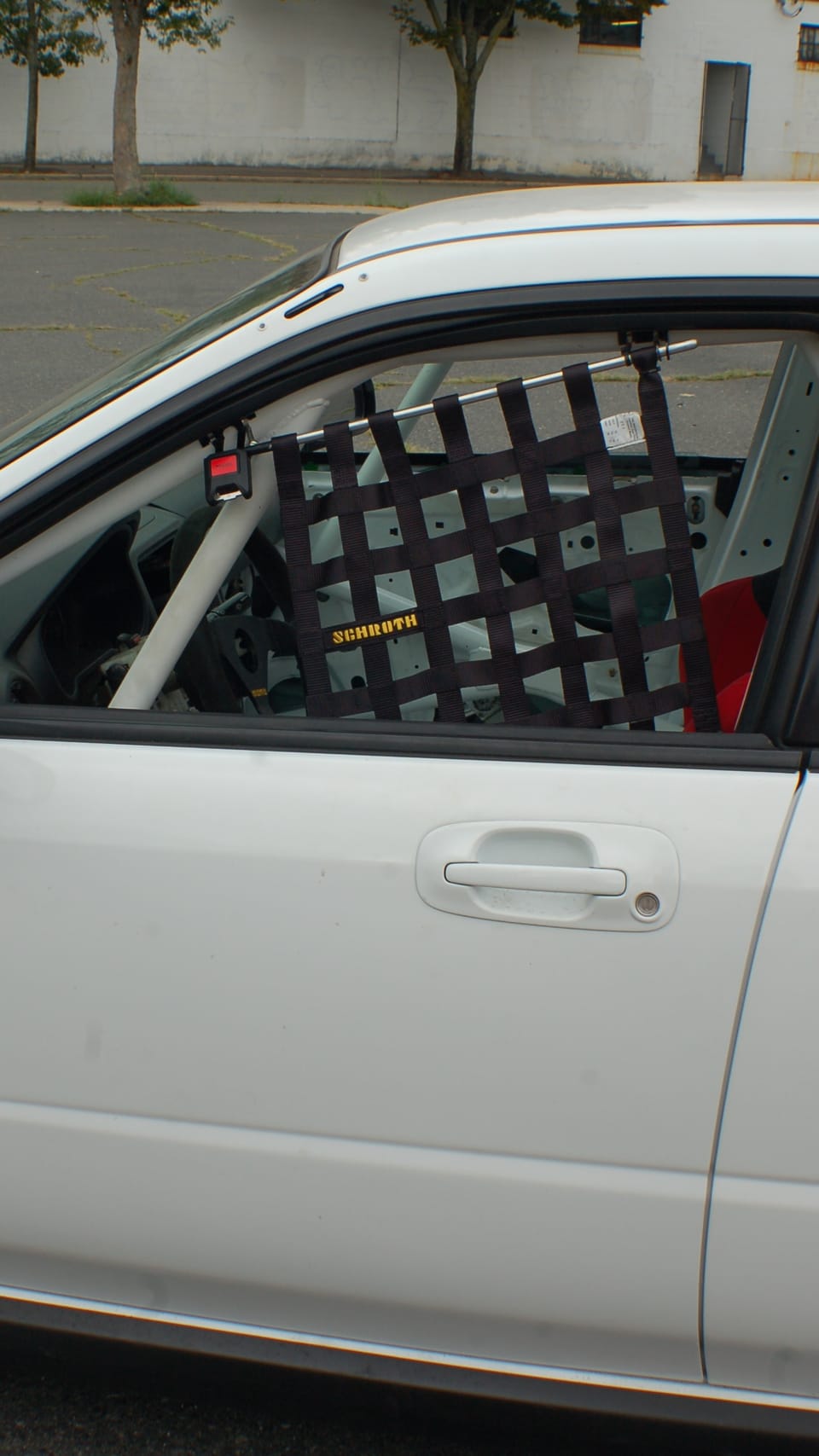 Passenger-side x-brace rollcage. Window safety net on driver side