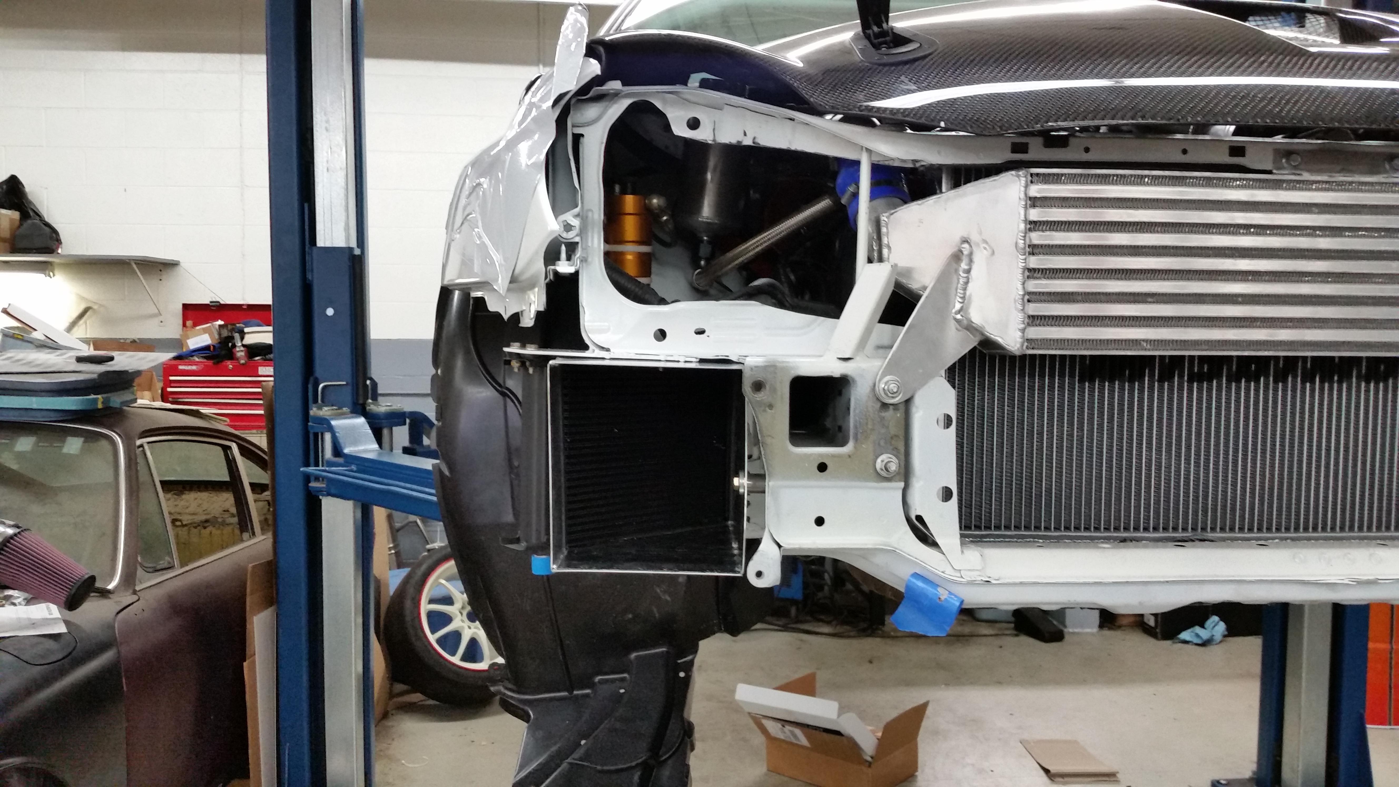 Mocal oil cooler setup (left), mounted in the front of the car. Front mounted intercooler and radiator also visible (right)