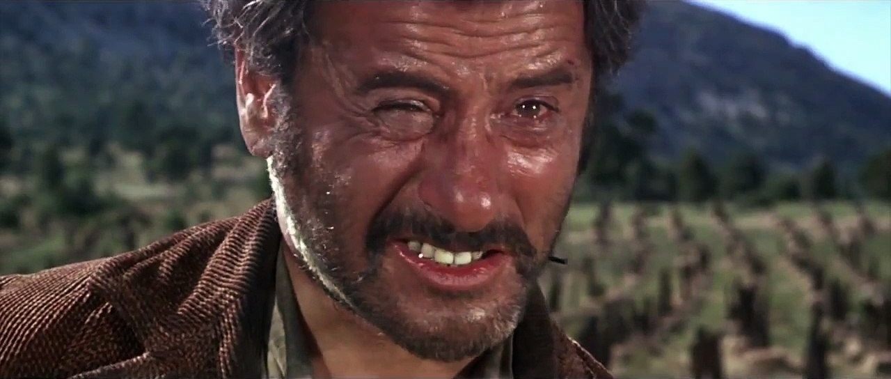 Tuco smiles, screenshot from the 1966 film The Good, the Bad and the Ugly)